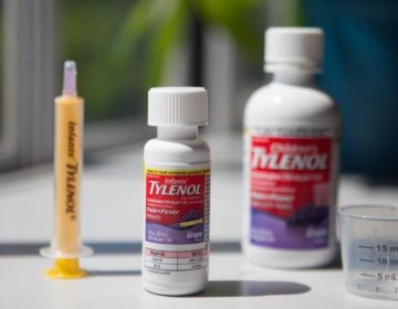 Infants' Tylenol comes with a dosing syringe, while Children's Tylenol has a plastic cup. Both contain the same concentration of the active ingredient, acetaminophen. (Ryan Kellman/NPR)