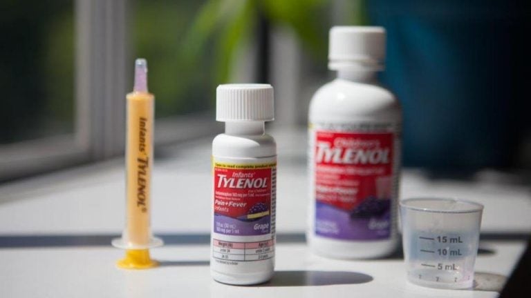tylenol1 Infants' Tylenol comes with a dosing syringe, while Children's Tylenol has a plastic cup. Both contain the same concentration of the active ingredient, acetaminophen. (Ryan Kellman/NPR)