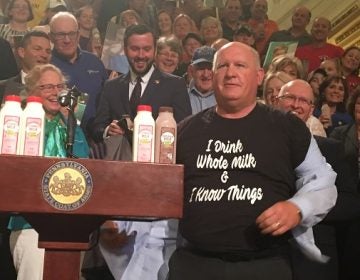 GOP Congressman Glenn Thompson displays his pro-dairy t-shirt to a surprised but appreciative crowd. (Katie Meyer/WITF)