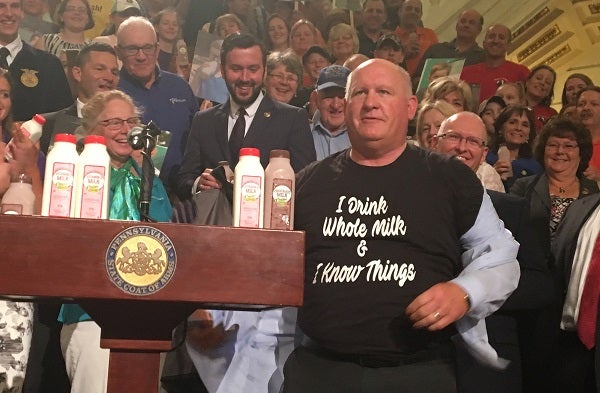 GOP Congressman Glenn Thompson displays his pro-dairy t-shirt to a surprised but appreciative crowd. (Katie Meyer/WITF)