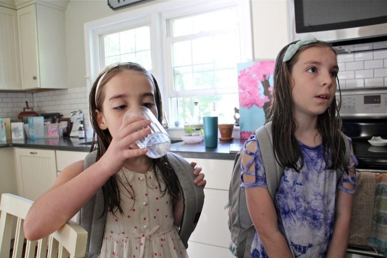 Emily Cutaiar, 8,  (left) and her sister Jessica, 9, know not to drink water from the tap in their Sellersville home. Their well was found to be contaminated with PFAS. (Emma Lee/WHYY)