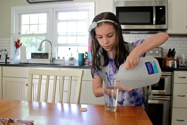 The Cutaiar family drinks only bottled water at their home in Sellersville, Pa. because the family's well was found to be contaminated with PFAS. (Emma Lee/WHYY)