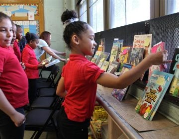 Angelis Leon, a third grader at Gilbert Spruance Elementary School, finds the books she ordered through the Book Trust. The non-profit allows young readers to choose their books.