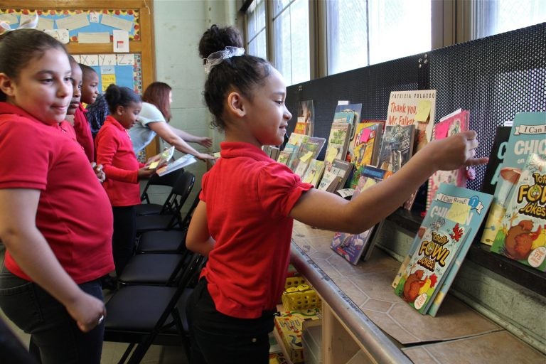 Angelis Leon, a third grader at Gilbert Spruance Elementary School, finds the books she ordered through the Book Trust. The non-profit allows young readers to choose their books.