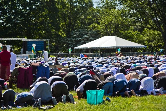 Members of the Muslim community pray at the end of Ramadan festival Eid-al-Fitr in Fairmount Park. (Kimberly Paynter/WHYY)