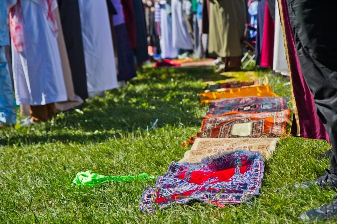 Members of the Muslim community pray at the end of Ramadan festival Eid-al-Fitr in Fairmount Park. (Kimberly Paynter/WHYY)