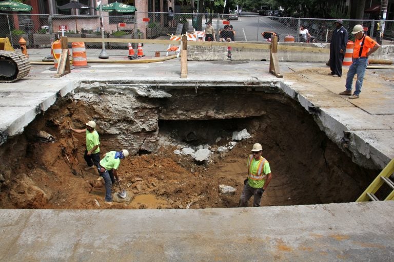 A sinkhole in Baltimore Avenue at 43rd Street was caused by a faulty sewer pipe. (Emma Lee/WHYY)
