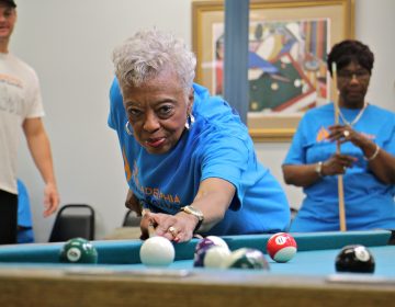 Mary Morris, 76, lines up her shot during the the Philadelphia Senior Games at West Oak Lane Senior Center. Morris, who has been playing pool since she was 12 years old, won her round against Pat Gathers, 77 (right)