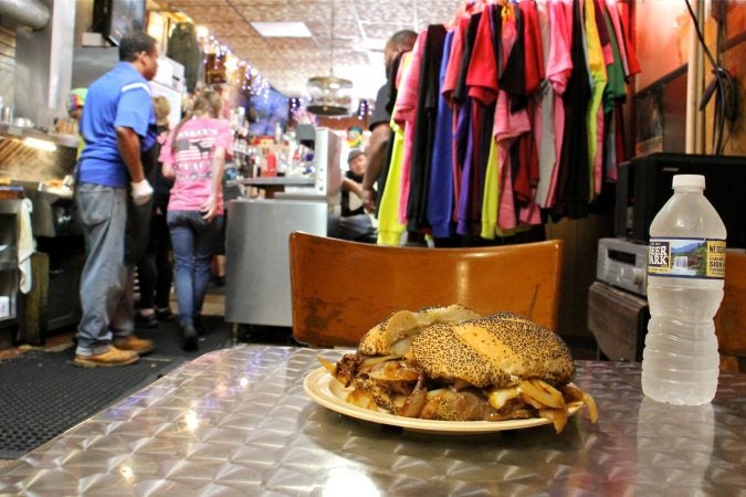 A Donkey's cheesesteak on a kaiser roll with the requisite fried onions. (Emma Lee/WHYY)