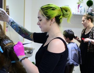 Kristina Amell and Grace Berry attend to clients at Starshine Salon, located on Manayunk's Main Street. (Bastiaan Slabbers for WHYY)