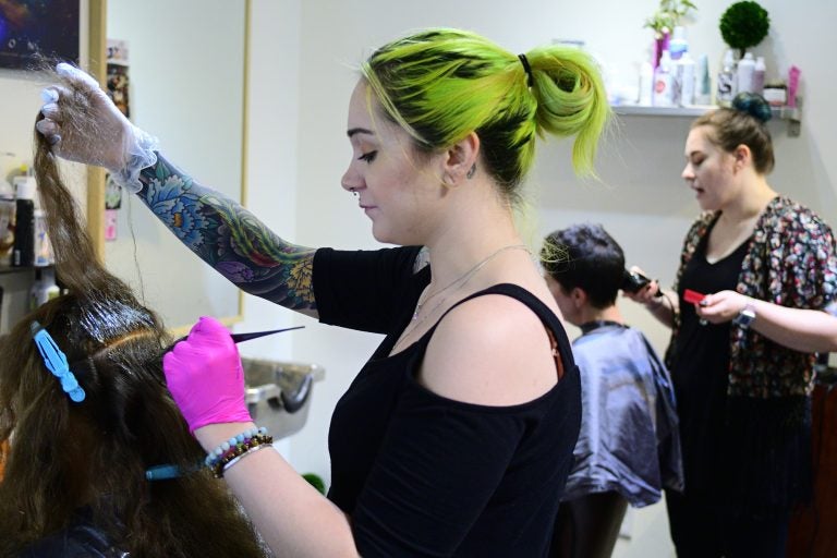 Kristina Amell and Grace Berry attend to clients at Starshine Salon, located on Manayunk's Main Street. (Bastiaan Slabbers for WHYY)