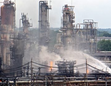 A fire burns at the Philadelphia Energy Solutions refinery hours after a series of early morning explosions at the 150-year-old industrial complex at 3100 W. Passyunk Ave. (Emma Lee/WHYY)