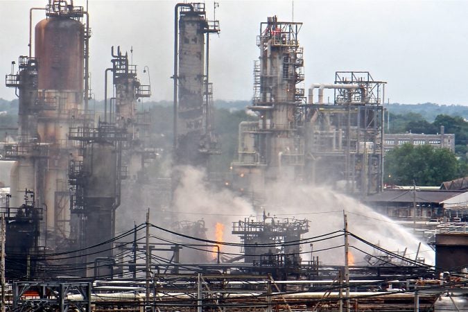 A fire burns at the Philadelphia Energy Solutions refinery hours after a series of early morning explosions at the 150-year-old industrial complex at 3100 W. Passyunk Ave. (Emma Lee/WHYY)