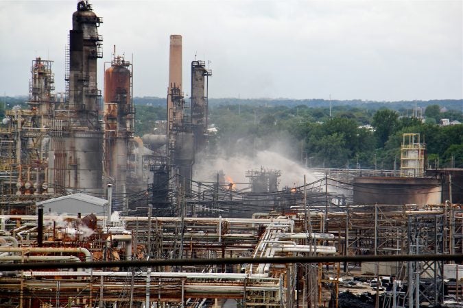 A fire burns at the Philadelphia Energy Solutions refinery hours after a series of early morning explosions at the 150-year-old industrial complex at 3100 W. Passyunk Ave. (Emma Lee/WHYY)