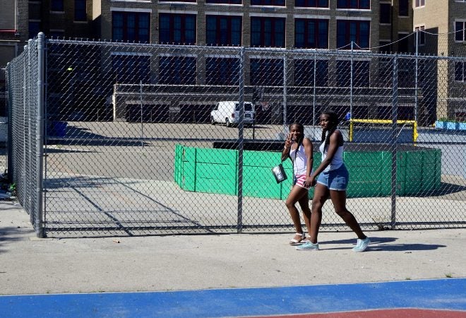 Parts of the school yard are fenced off, creating a separation between a dedicated area used by the school and one by the Belmont neighborhood community. (Bastiaan Slabbers for WHYY)