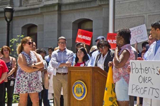 Councilwoman Janie Blackwell, joined by council members Bobby Henon, Bill Greenlee, and Helen Gym, speaks at a rally to save Hahnemann hospital from closing at City Hall. (Kimberly Paynter/WHYY)