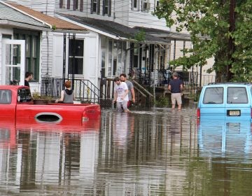 File photo: Residents of High Street in Westville, N.J., return to their homes as flood waters begin to recede on June 20, 2019. (Emma Lee/WHYY)