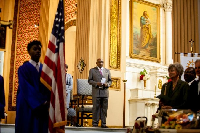 President of the Gesu School Bryan Carter stands during the school's graduation ceremony earlier this month. (Brad Larrison for WHYY)