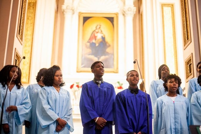 Graduating students of the Gesu School sing hymns during the schools graduation ceremony earlier this month. (Brad Larrison for WHYY)