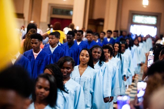 Students walk in lockstep inside the Church of the Gesu before the school's graduation ceremony earlier this month. (Brad Larrison for WHYY)