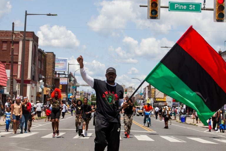 The Juneteenth Parade makes its way down 52nd Street in West Philadelphia Saturday where it was being held for the first year after moving from Center City Philadelphia. (Brad Larrison for WHYY)