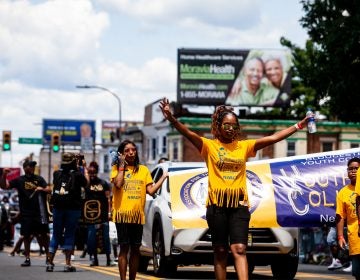 The Juneteenth Parade makes its way down 52nd Street in West Philadelphia Saturday where it was being held for the first year after moving from Center City Philadelphia. (Brad Larrison for WHYY)