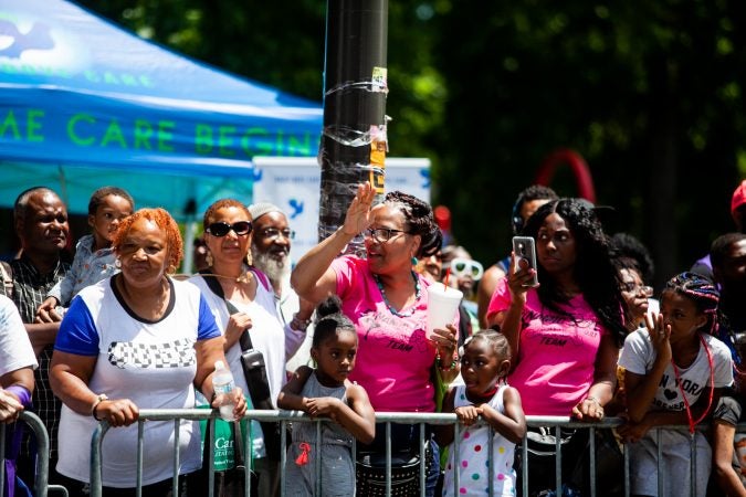 The Juneteenth Parade makes its way down 52nd Street in West Philadelphia Saturday where it was being held for the first year after moving from Center City Philadelphia. (Brad Larrison for WHYY)