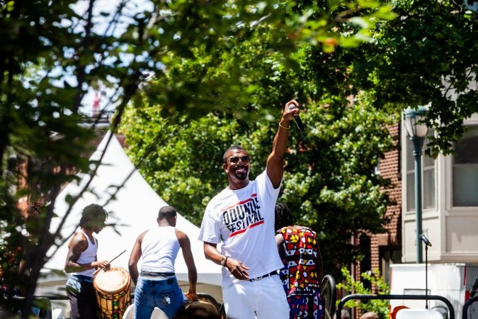 Host of the Odunde Festival Six King hypes up the crowd on South Street Sunday during the festival celebrating African and Carribean culture. (Brad Larrison for WHYY)