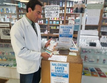 File photo: Anthony Minniti, a pharmacist and the owner of Bell Pharmacy in Camden, displays some of the educational material he handed out to people claiming free doses of naloxone on Tuesday, June 18, 2019. (Nicholas Pugliese/WHYY)