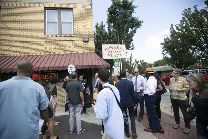 A group of activists gather for a tour of Camden to show the inequality in the city even after new businesses moved in (Miguel Martinez for WHYY)