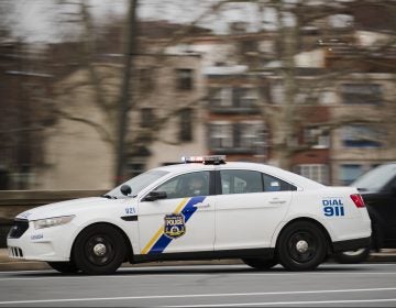 A police car drives with its lights flashing in Philadelphia