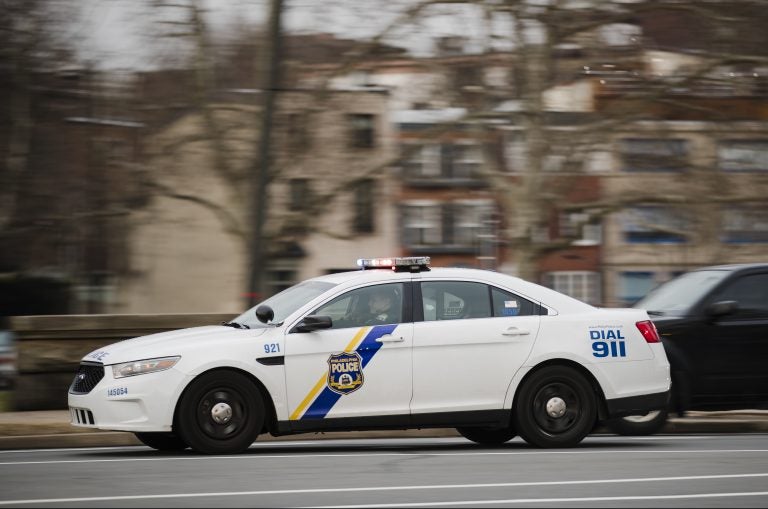 A police car drives with its lights flashing in Philadelphia