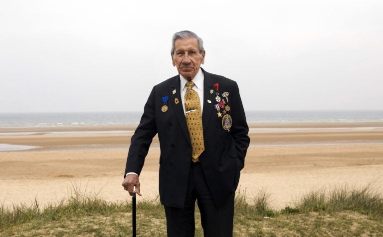 World War II and D-Day veteran Charles Norman Shay, from Indian Island, Maine, poses on a dune at Omaha Beach in Saint-Laurent-sur-Mer, Normandy, France, Wednesday, May 1, 2019. Shay was a combat medic on D-Day, assigned to an assault battalion in the first wave of attacks on D-Day, June 6, 1944. (Virginia Mayo/AP Photo)