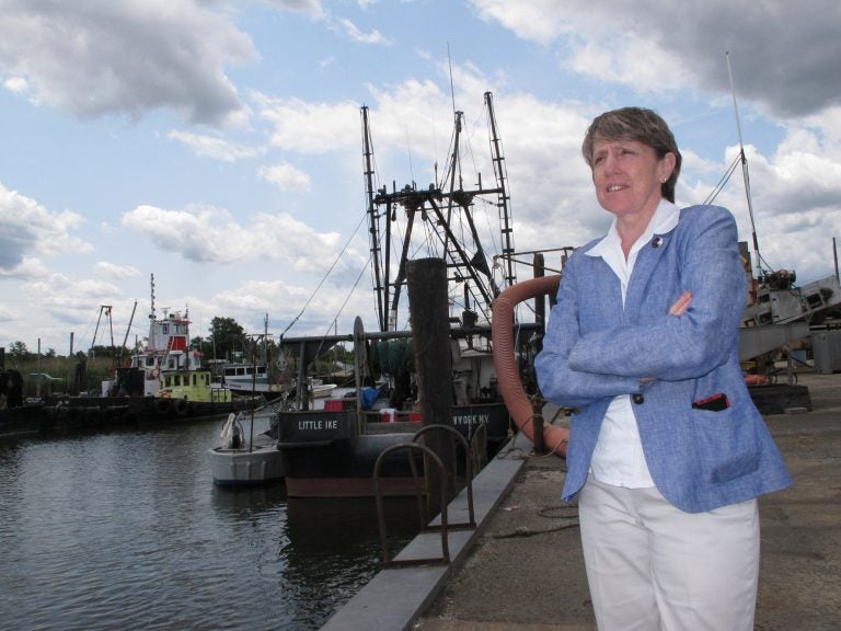 In this June 3, 2019 photo Cindy Zipf, executive director of the Clean Ocean Action environmental group, discusses a plan to build a natural gas pipeline that would run near this Middletown, N.J,. fishing depot. New Jersey environmental officials are due to decide Wednesday, June 5 on key permits for a nearly $1 billion pipeline that would bring natural gas from Pennsylvania through New Jersey, out into Raritan Bay and into the ocean before reaching New York and Long Island. (Wayne Parry/AP Photo)