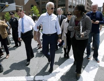 Former vice president and Democratic presidential candidate Joe Biden speaks with a woman as he walks with Boston Mayor Marty Walsh, left, on Wednesday, June 5, 2019, in downtown Boston. (Steven Senne/AP Photo)