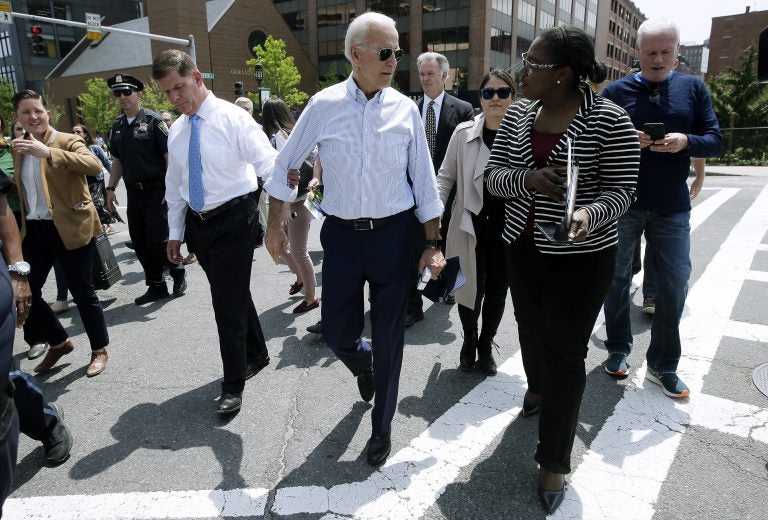 Former vice president and Democratic presidential candidate Joe Biden speaks with a woman as he walks with Boston Mayor Marty Walsh, left, on Wednesday, June 5, 2019, in downtown Boston. (Steven Senne/AP Photo)