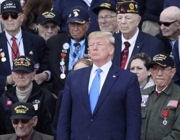 U.S. President Donald Trump stands with World War II veterans during a ceremony to mark the 75th anniversary of D-Day at the Normandy American Cemetery in Colleville-sur-Mer, Normandy, France, Thursday, June 6, 2019. World leaders are gathered Thursday in France to mark the 75th anniversary of the D-Day landings. (David Vincent/AP Photo)