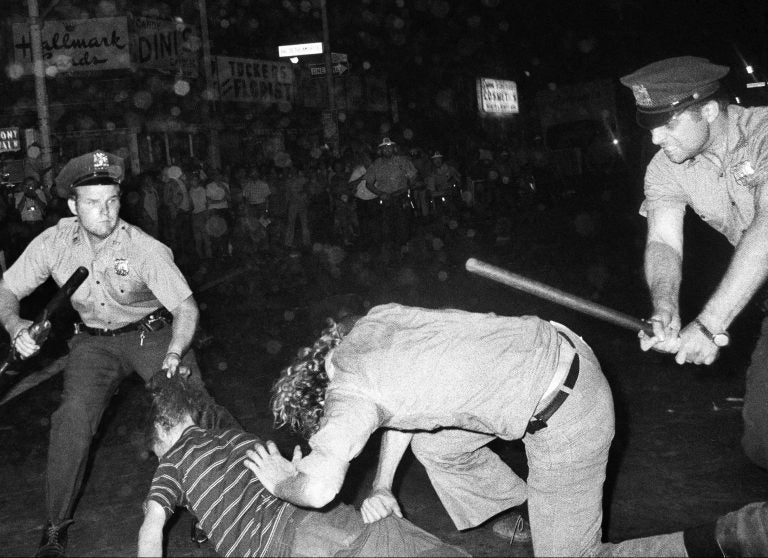 FILE - In this Aug. 31, 1970 file photo, an NYPD officer grabs a youth by the hair as another officer clubs a young man during a confrontation in Greenwich Village after a Gay Power march in New York. A year earlier, the June 1969 uprising by young gays, lesbians and transgender people in New York City, clashing with police near a bar called the Stonewall Inn, was a vital catalyst in expanding LGBT activism nationwide and abroad. (AP Photo/File)