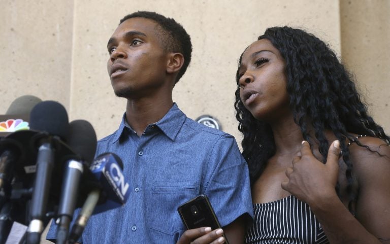 Iesha Harper, (right), answers a question during a news conference as she is joined by her fiancee Dravon Ames, (left), at Phoenix City Hall, Monday, June 17, 2019, in Phoenix. Ames and his pregnant fiancée, Harper, who had guns aimed at them by Phoenix police during a response to a shoplifting report, say they don't accept the apologies of the city's police chief and mayor and want the officers involved to be fired. (Ross D. Franklin/AP Photo)