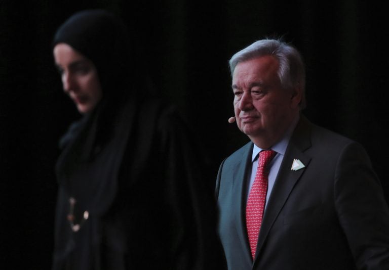 United Nations Secretary General Antonio Guterres, right, follows the UAE Youth Minister, Shamma Al Mazrim as they take the stage at the opening ceremony of the United Nations climate change summit in Abu Dhabi, United Arab Emirates, Sunday, June 30, 2019. (Kamran Jebreili/AP Photo)