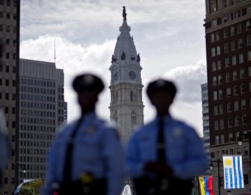 Police stand along Benjamin Franklin Parkway as City Hall stands in the background, Friday, Sept. 25, 2015, in Philadelphia. (AP Photo/David Goldman)