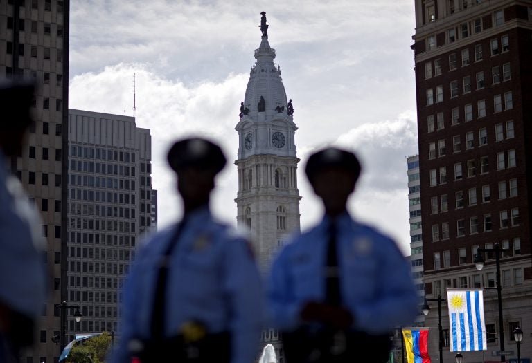 Police stand along Benjamin Franklin Parkway as City Hall stands in the background, Friday, Sept. 25, 2015, in Philadelphia. (AP Photo/David Goldman)