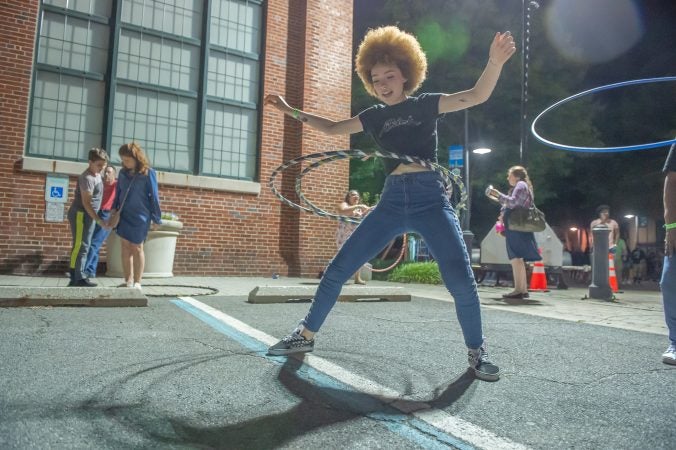 Gianni Jones takes her turn with the hula hoops, which were one of the Art All Night attractions. (Jonathan Wilson for WHYY)