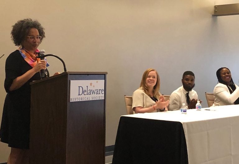 Raye Jones Avery of the Christina Cultural Arts Center addressed the audience, flanked by, (from left), attorney Kyle Evans Gay, community organizer Dubard McGriff and doctoral candidate Cimone Philpotts. (Cris Barrish/WHYY)