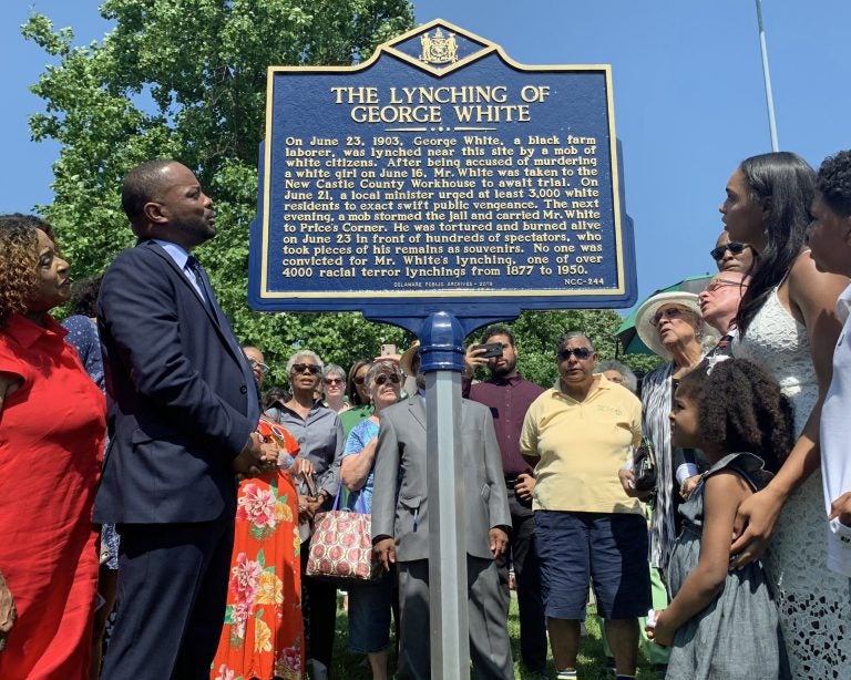 Sen. Darius Brown, Savannah Shepherd and others read the words on The Lynching of George White Historical Marker just minutes after it was unveiled at Greenbank Park on June 23. (Scott Goss/Delaware Senate Majority Caucus) 