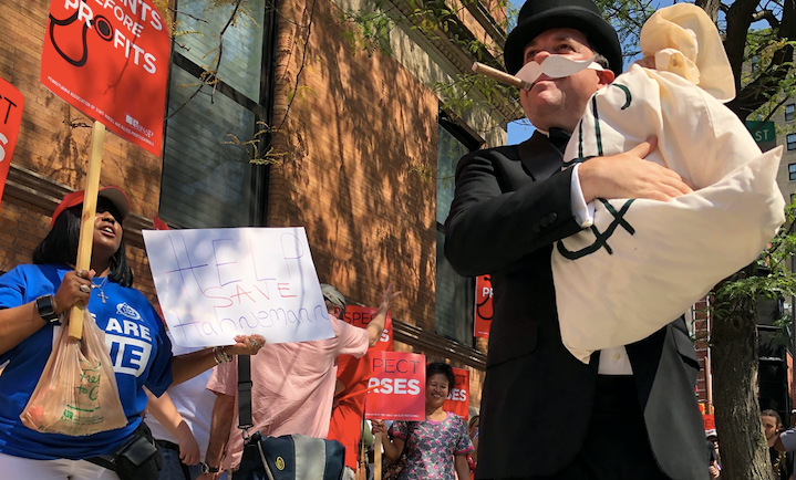 Hospital workers gathered Friday morning outside Hahnemann owner Joel freedman’s Rittenhouse apartment building to demand he keep the hospital open (Nina Feldman/WHYY)