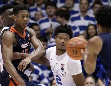 Duke's Cam Reddish (2) keeps an eye on the ball against Virginia's De'Andre Hunter, (left), and Braxton Key (2) during the second half of an NCAA college basketball game in Durham, N.C., Saturday, Jan. 19, 2019. Duke won 72-70. (Gerry Broome/AP Photo)