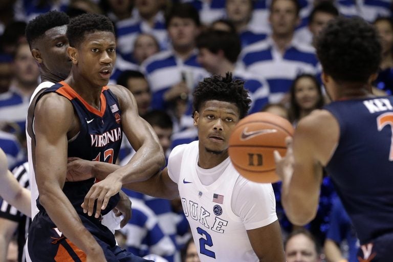 Duke's Cam Reddish (2) keeps an eye on the ball against Virginia's De'Andre Hunter, (left), and Braxton Key (2) during the second half of an NCAA college basketball game in Durham, N.C., Saturday, Jan. 19, 2019. Duke won 72-70. (Gerry Broome/AP Photo)