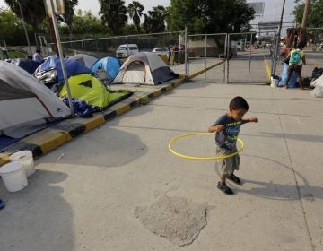 William Linares, a 5-year-old from Honduras, plays in an encampment where he is living near the international bridge in Matamoros, Mexico, on April 30. The boy is traveling with his mother, Suanny Gomez, and seeking asylum in the United States. (Eric Gay/AP Photo)