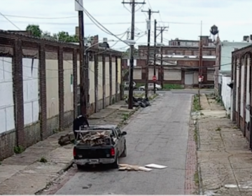 Illegal dumpers throw construction debris on a Philadelphia street in a video screen capture from a video released by the City of Philadelphia.